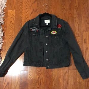 Black denim jacket with designed patches embedded